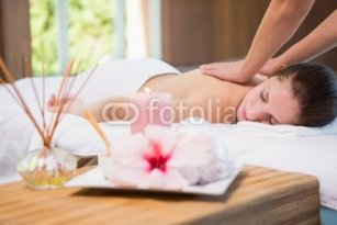 Attractive_woman_receiving_back_massage_at_spa_center.jpg