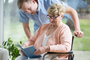 Handicapped_woman_reading_book.jpg